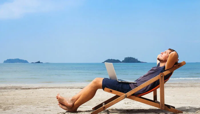 man-deck-chair-beach-laptop
